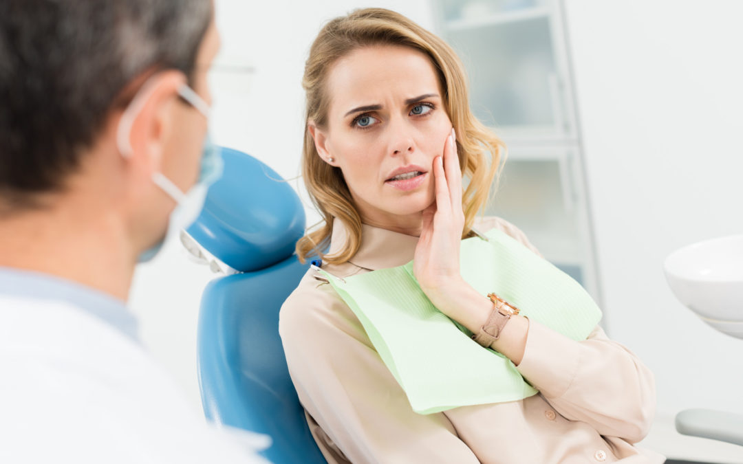 woman seeing dentist for impacted tooth
